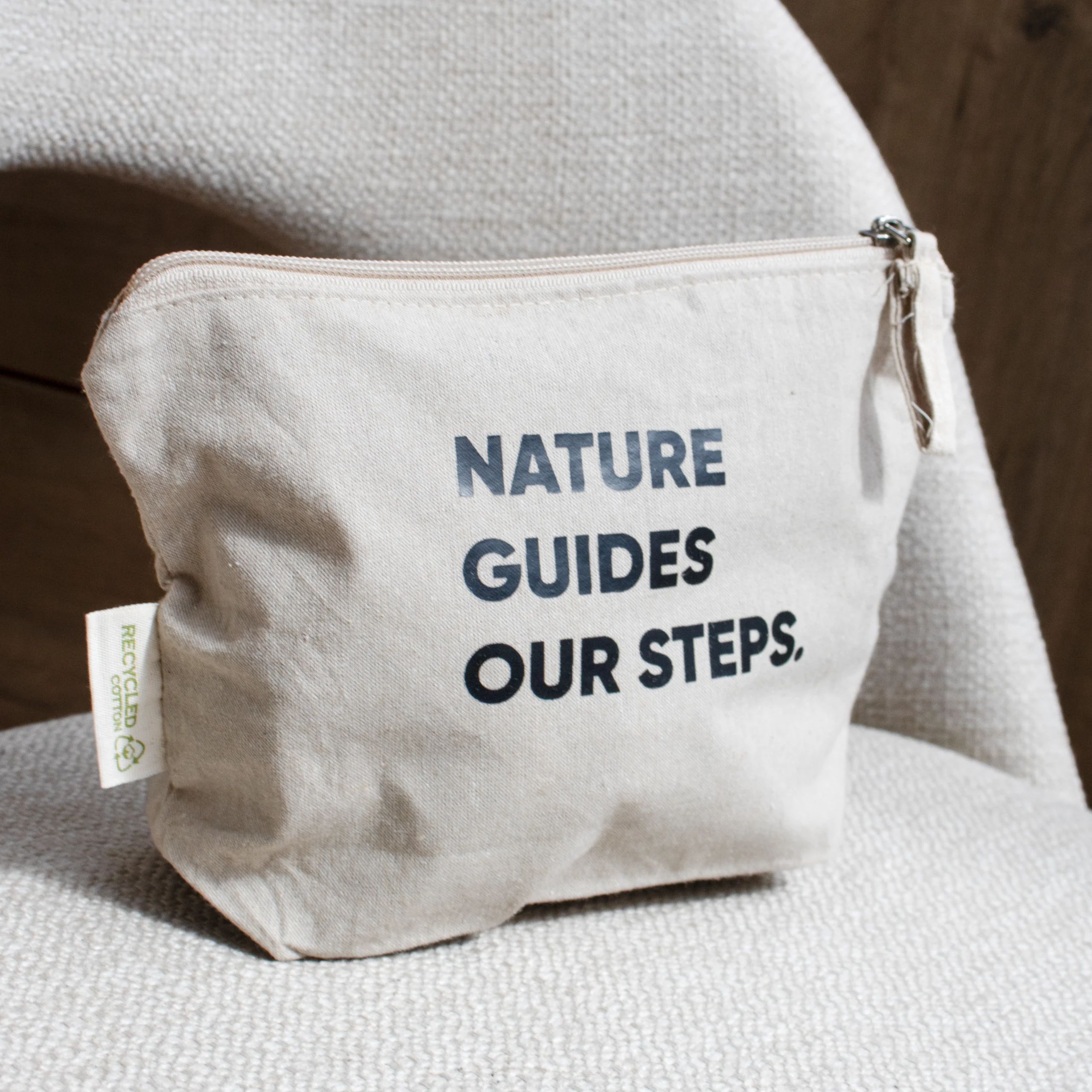 Neceser algodón ecológico COTTO Beige Cuadrada Neceser algodón personalizado con texto negro sobre silla gris