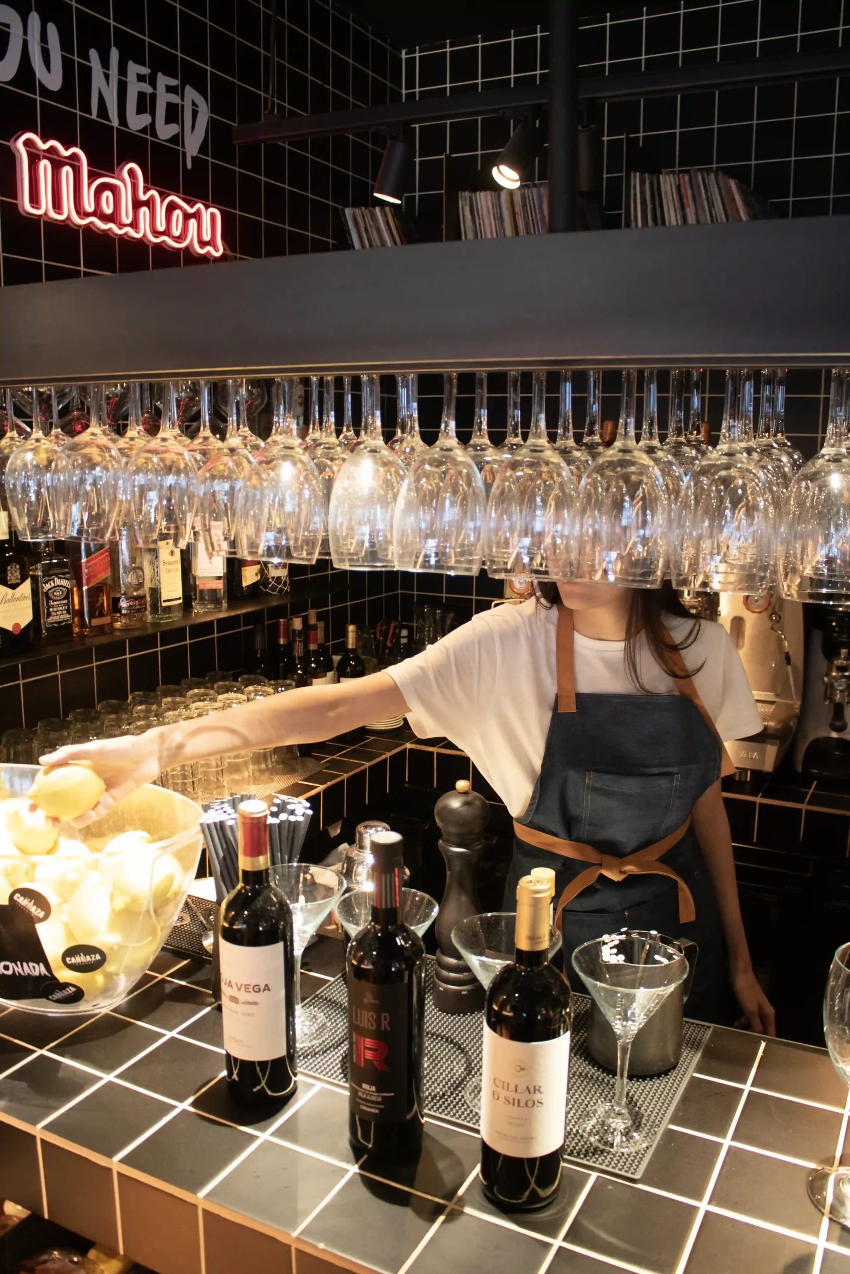 Custom denim apron with white logo, waitress model at a restaurant