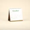 Calendario plantable de mesa TRIGA Calendario plantable de mesa abierto en el mes de octubre