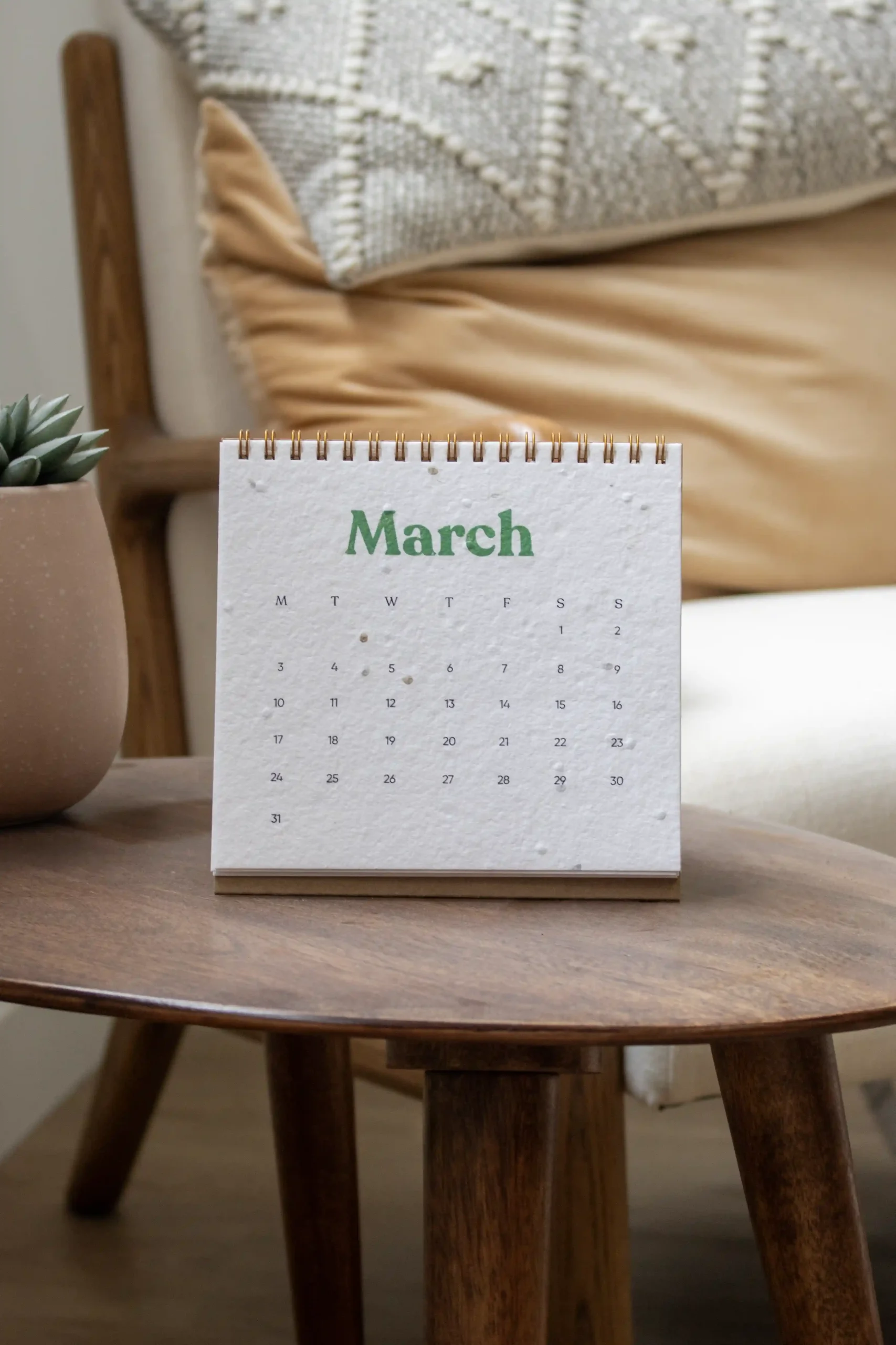 Calendario plantable de mesa abierto sobre una mesa de madera