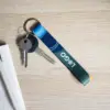 llavero ecológico personalizado con logo con llaves sobre mesa de madera