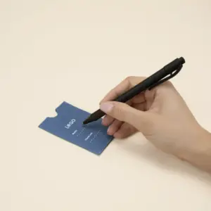 mano escribiendo con un bolígrafo en un porta llaves de hotel azul personalizado con la palabra logo en blanco