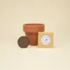 Kit plantable de barro con una pastilla de tierra, y un sobre con semillas