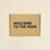Caja de cartón cerrada personalizada con el texto 'welcome to the team'