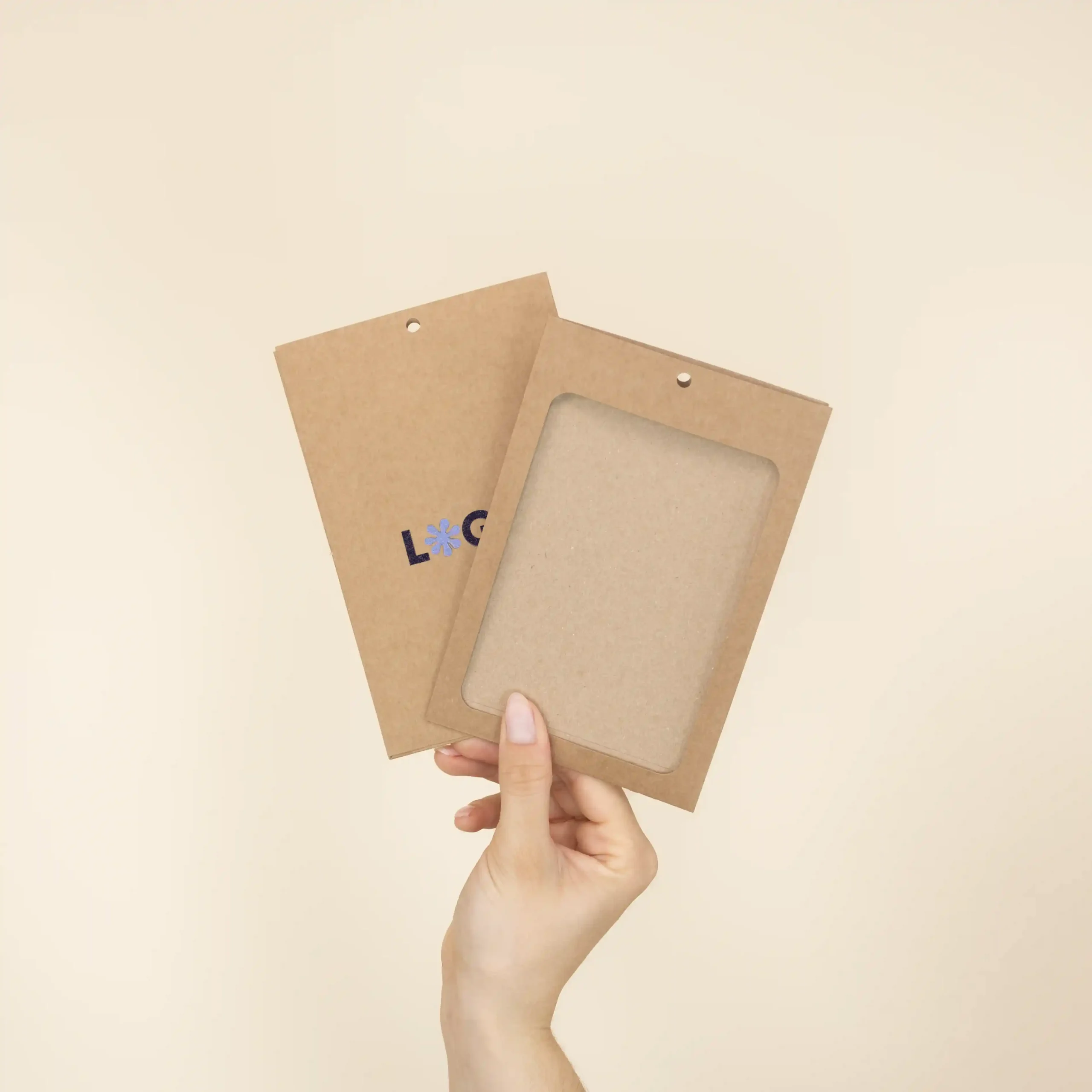 Mano mostrando dos fundas de acreditación en cartón kraft marrón