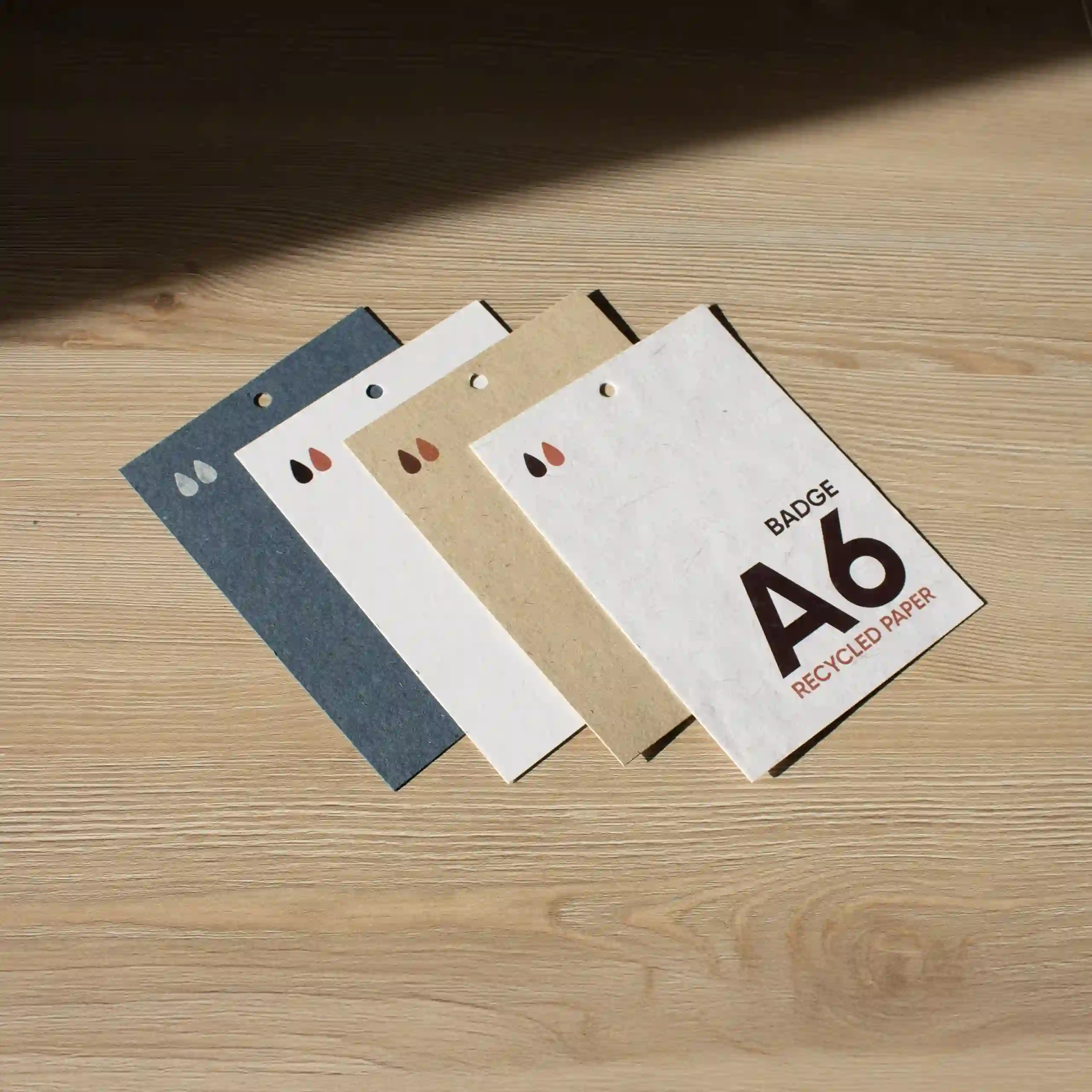 Acreditación A6 papel ecológico Cuatro acreditaciones A6 impresas en papeles ecológicos sobre una superficie de madera