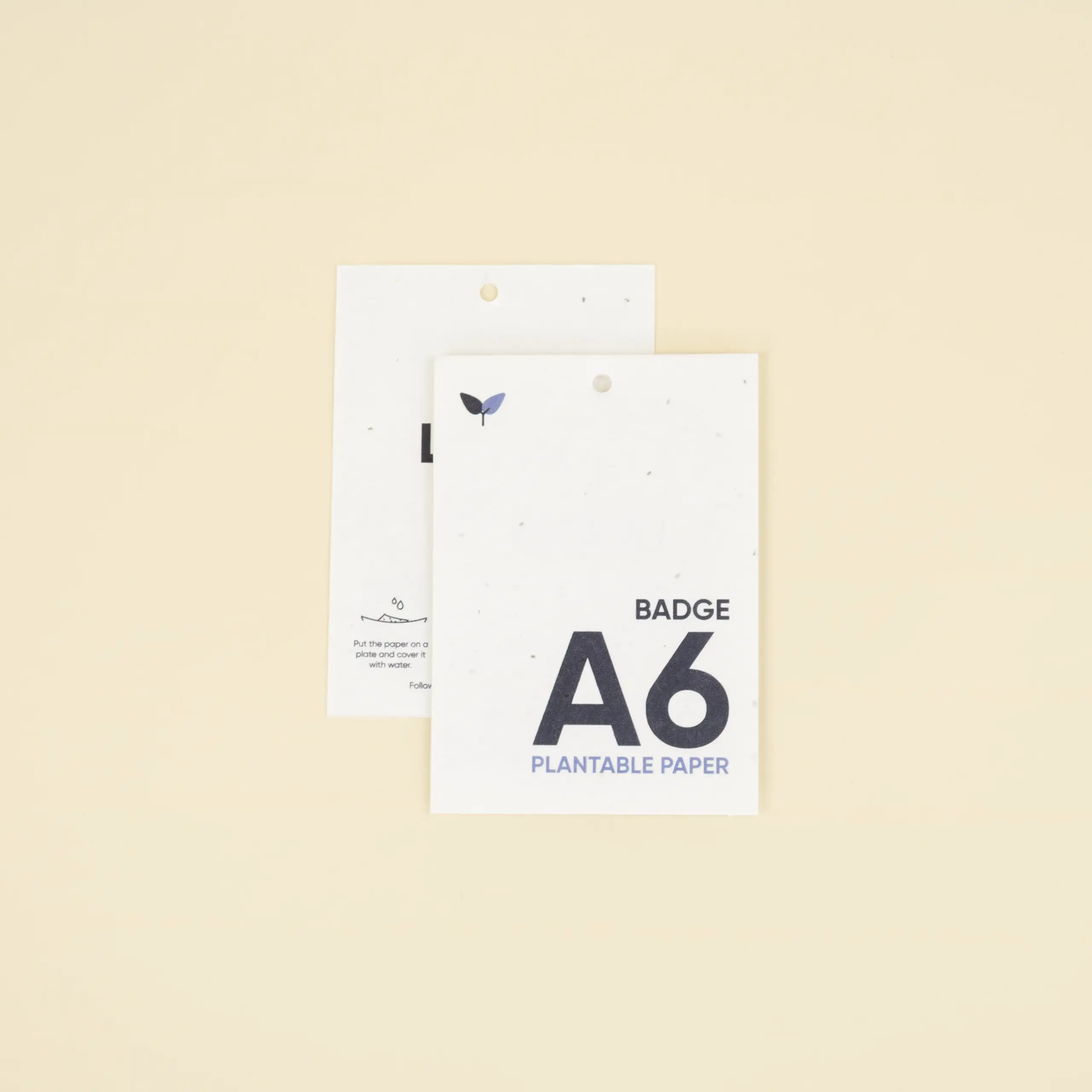 Dos acreditaciones A6 impresas en papel plantable superpuestas una encima de la otra