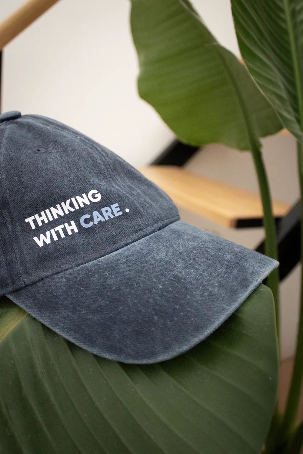 Personalised vintage cap VINTY Gorra vintage azul con logo sobre una planta con escaleras de fondo