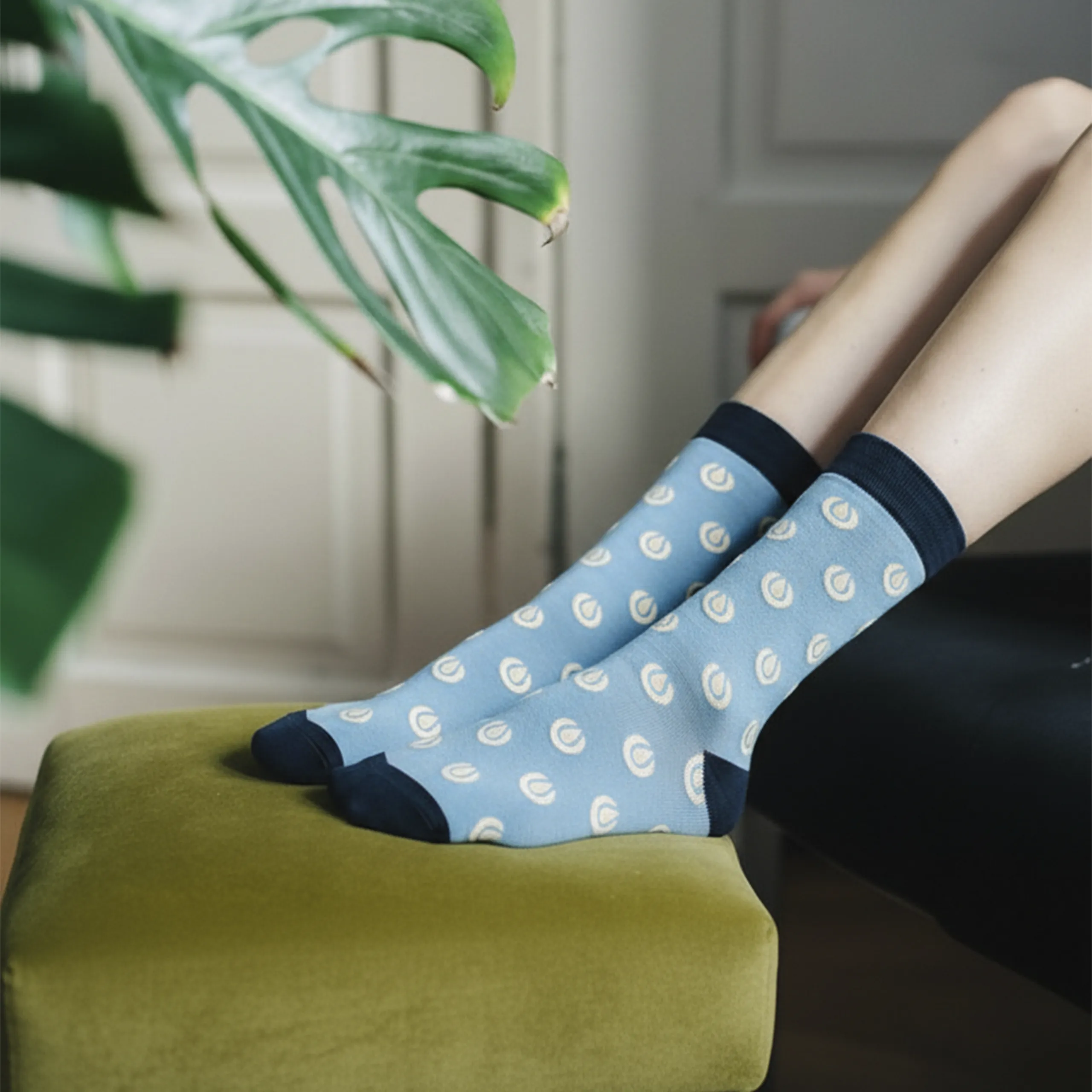 Piernas sobre un sofá con calcetines azules personalizados